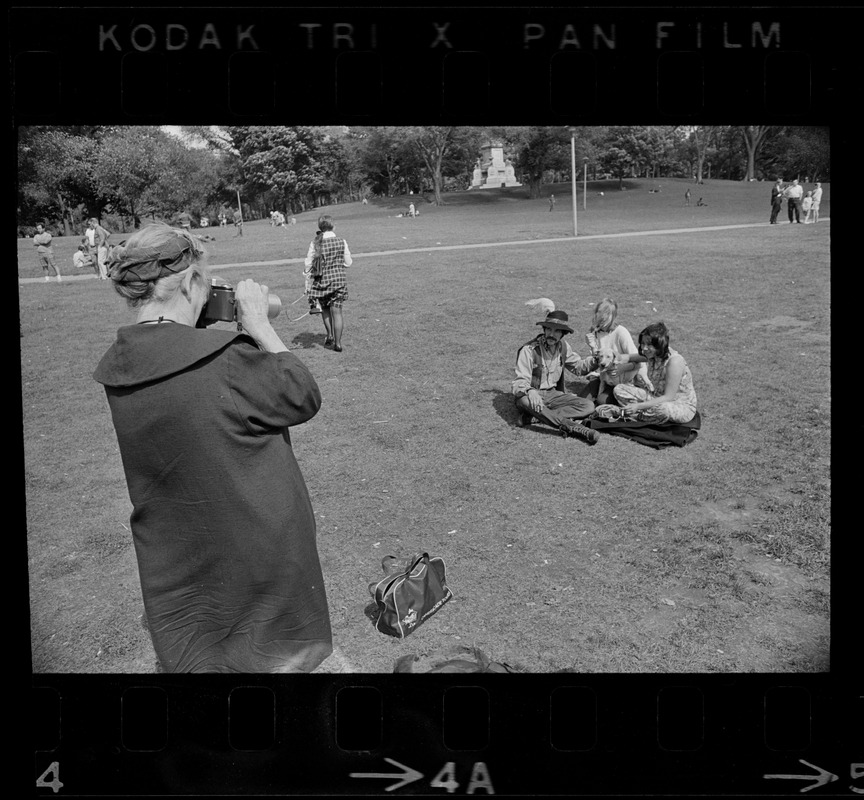 Hippies on the Boston Common being photographed by a woman