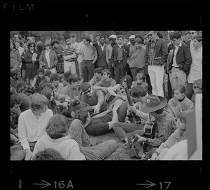 Spectators gathered around hippies playing music on the Boston Common