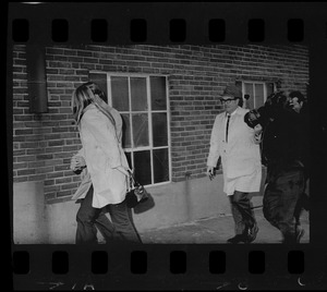 Photographer trailing a couple outside a building