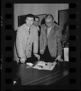 Two men inspecting evidence