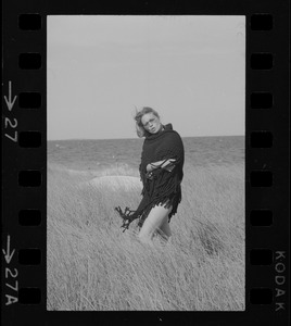 Faye Dunaway standing in a field