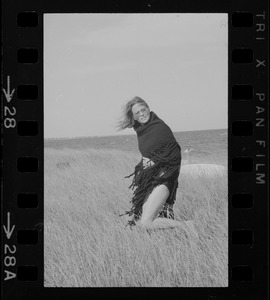 Faye Dunaway standing in a field