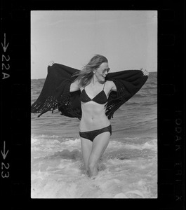 Faye Dunaway standing in the surf