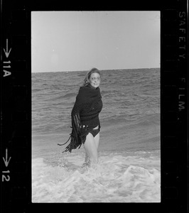 Faye Dunaway standing in the surf