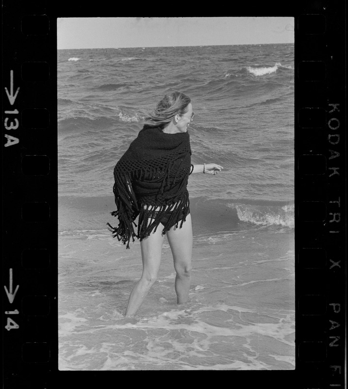 Faye Dunaway standing in the surf