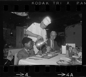 Guest of the United States Navy aboard the Aircraft carrier USS Intrepid in Boston Harbor, Riki Jackson of Dorchester is served by First Class Commissaryman John Oaks