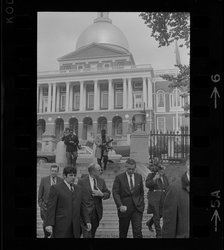 New MBTA Board Chair, Robert Wood, left, and Governor Sargent, right, entering the Boston Common with the State House seen behind them