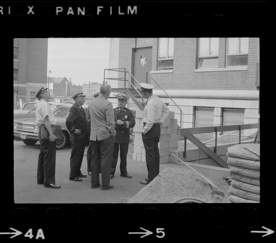 Officers standing and speaking outside with a man