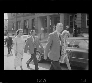 Outside Middlesex County Courthouse are Mrs. Florence Volpe and Arthur Volpe walking behind Woburn ex-Mayor Edward F. Gill and his wife