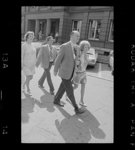 Outside Middlesex County Courthouse are Mrs. Florence Volpe and Arthur Volpe walking behind Woburn ex-Mayor Edward F. Gill and his wife