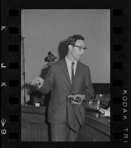 Timothy Asch of Cambridge seen with camera used to photograph "Titicut Follies" State House hearing
