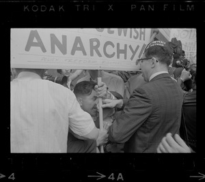 Josef Mlot-Mroz holding sign outside the Federal Building in Boston during protests after the sentencing of Dr. Spock and others on draft conspiracy charges