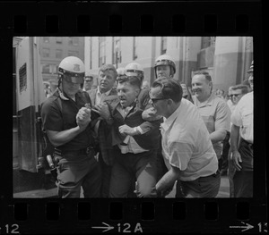 Josef Mlot-Mroz being apprehended during protests after the sentencing of Dr. Spock and others for draft conspiracy charges