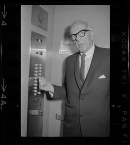 Dr. Benjamin Spock on elevator during recess at pre-trial hearing at Federal Court