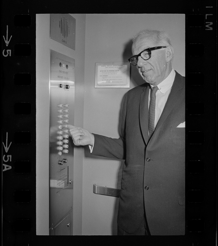 Dr. Benjamin Spock on elevator during recess at pre-trial hearing at Federal Court