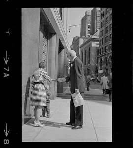 Mrs. Barbara McCoy introduces son Patrick to Dr. Benjamin Spock on street outside Federal Courthouse where he is appearing for pre-trial hearing