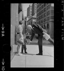 Mrs. Barbara McCoy introduces son Patrick to Dr. Benjamin Spock on street outside Federal Courthouse where he is appearing for pre-trial hearing