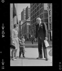 Mrs. Barbara McCoy introduces son Patrick to Dr. Benjamin Spock on street outside Federal Courthouse where he is appearing for pre-trial hearing