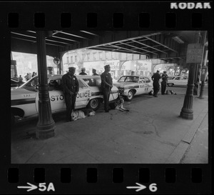 Police surveillance at a transportation station after disturbance during Puerto Rican Day celebration in Blackstone Park