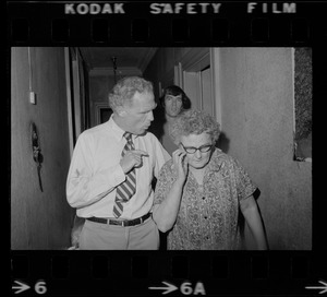 Mayor White and an older woman walking through a hallway