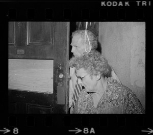 Mayor White and an older woman standing by a door