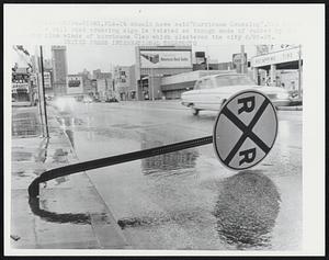 It should have said "Hurricane Crossing". The steel of a rail road crossing sign is twisted as though made of rubber by the 110 mph winds of hurricane Cleo which plastered the city 8/26-27.