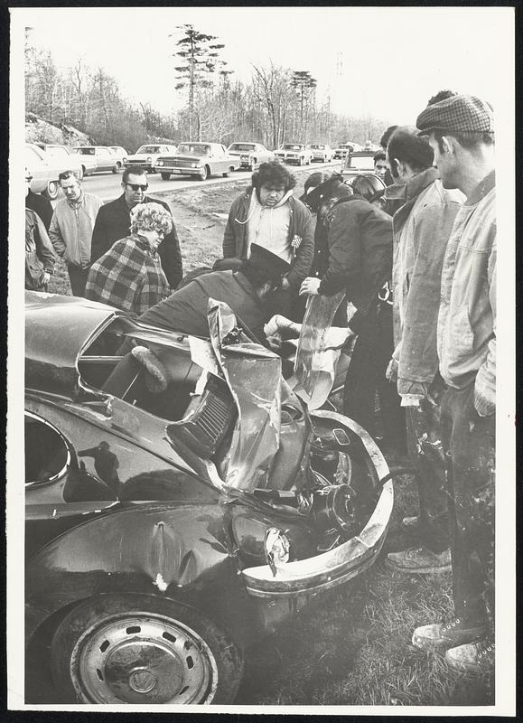 Randolph + Stoughton. Firemen get ready to put air splint on a young girl who was hurst as her foreign was blown off Rt 24 in Randolph about 3.00 PM today and overturned 3 times. She was taken to Cardinal Cushing Hospital Brockton.