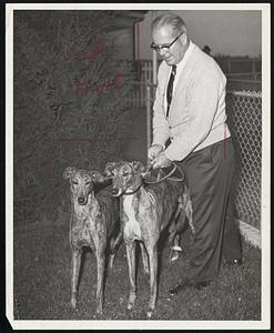 Florida-Bred greyhounds are welcomed to New England Bill L’Italien, presiding judge at Taunton Dog Track. Hi Betty A. and Hi Joey are from Dan Ahearn’s 21-greyhounds string and are awaiting schooling races that start Wednesday. The 1964 meeting opens Friday, Aug. 28.