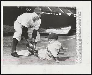 Whiz Kid, Junior Edition--Catcher Andy Seminick of the Phillies, gives his young son, Andy, a few pointer in sliding into second base during the Phils warmup today at Shibe Park. The Phils held a workout to get ready for tomorrow's World Series opener.