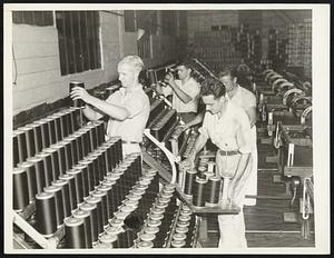 Strike's On - They Put Away the Spools. Workers in the Thread, Inc. mill at Gastonia, N. C. put away the spools after pickets persuade them to close down the mill. Several small mills were closed in this area by roving bands of pickets who went from one to another to persuade the workers to come out.