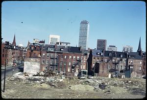 Piles of garbage, possibly from a demolished building, Prudential Tower in the background
