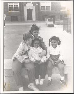 Cheryl, Echa Mojica-Lullanda (in back), Lisa Kilburn and Jessica Mojica-Lullanda, sitting outside at Newtowne Court