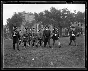 Governor Alvan Fuller walks with men in uniform