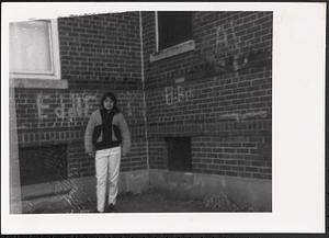 Young person standing in a courtyard area