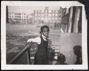 Girl in school uniform outside Newtowne Court