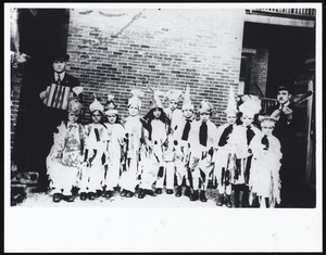 Portuguese 11 young children in costume and two male musicians, location unknown