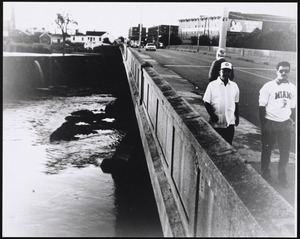 Pedestrians and cars crossing a bridge