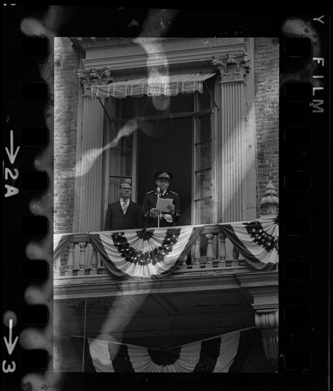Unidentified uniformed man speaking from balcony of the Old State House