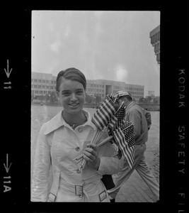 Unidentified woman holding small flags at City Hall on Fourth of July