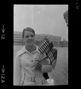 Unidentified woman holding small flags at City Hall on Fourth of July