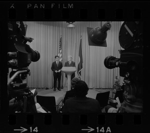 Television cameras and press equipment frame Mayor Kevin White and the candidate for Lieutenant Governor, Michael Dukakis, as they answer questions