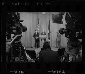 Television cameras and press equipment frame Mayor Kevin White and the candidate for Lieutenant Governor, Michael Dukakis, as they answer questions