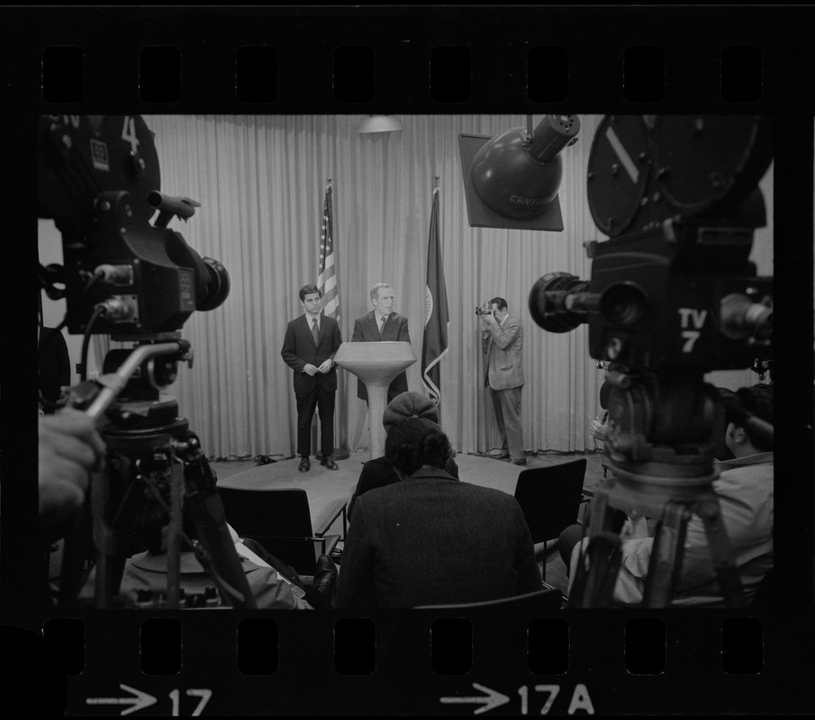 Television cameras and press equipment frame Mayor Kevin White and the candidate for Lieutenant Governor, Michael Dukakis, as they answer questions