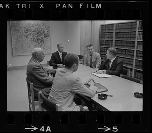 Five unidentified men around a conference table