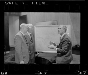 Boston Mayor Kevin White examines hurricane chart with two unidentified men