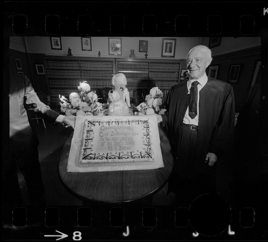 Chief Justice Elijah Adlow of Boston Municipal Court displays cake