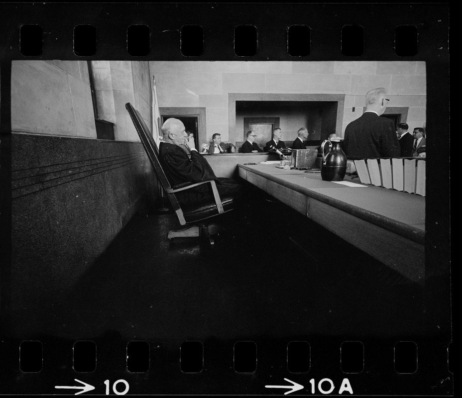 Chief Justice Elijah Adlow of Boston Municipal Court looking at the