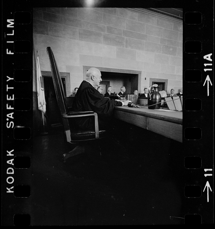 Chief Justice Elijah Adlow of Boston Municipal Court looking at the