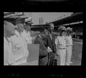 Two unidentified men and six unidentified Naval officers participating in ceremony at Fenway Park