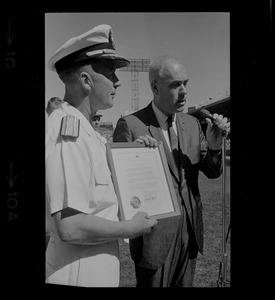 Dick O'Connell, general manager of Red Sox, accepts citation from Rear Adm. Richard Fowler, chief of Naval Air Reserve Training, at Fenway Park, honoring Tom Yawkey for patriotism and generosity to servicemen